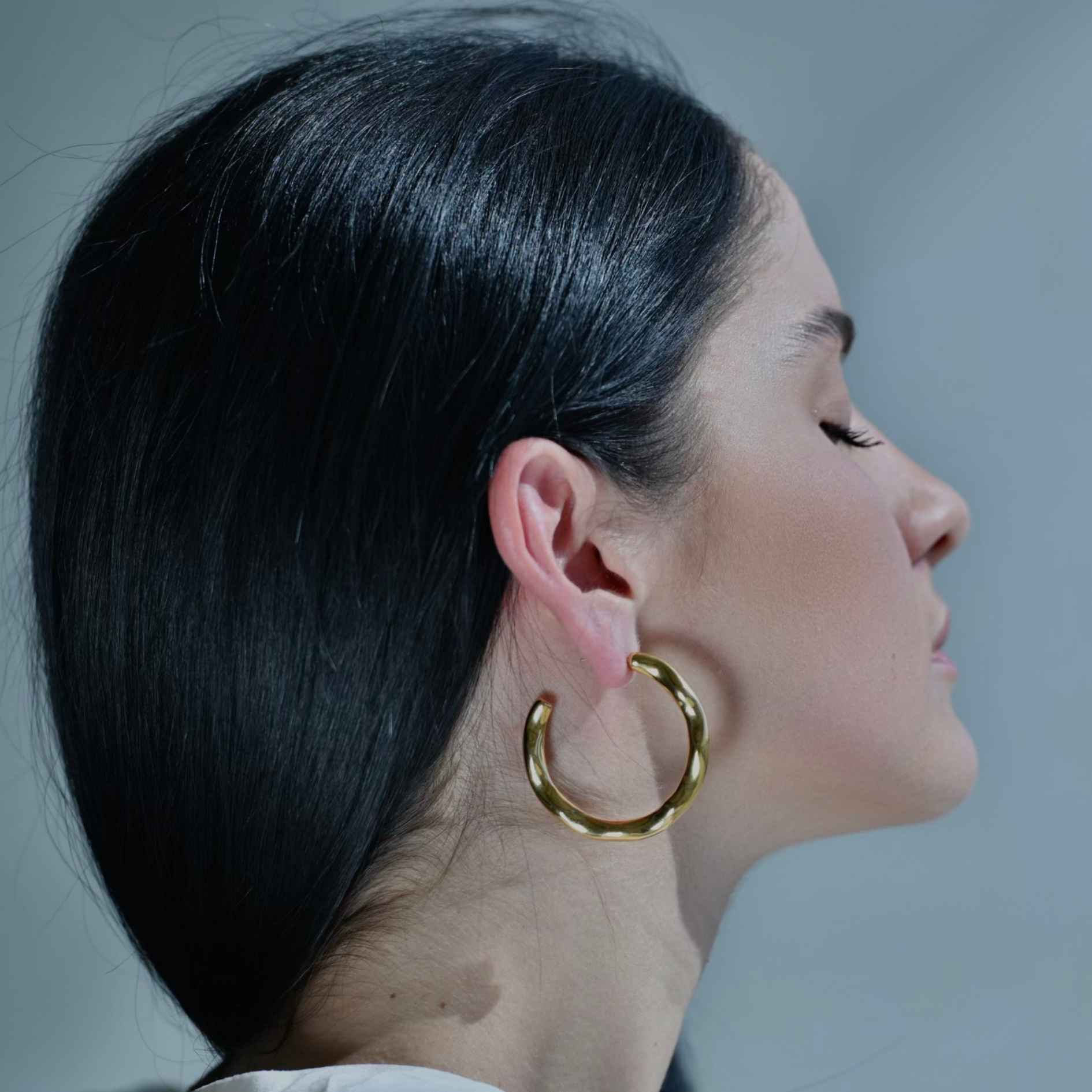 Gold hoop earrings with irregular surface. Big size of gold round earrings. Irregular surface.