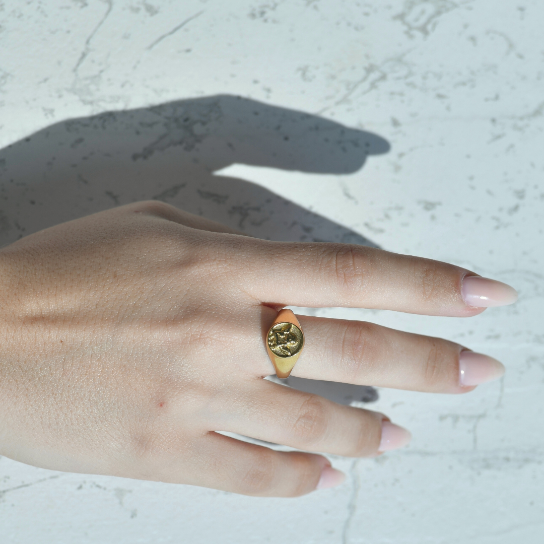 Angel Gold Ring. Gold ring with a square design of an angel on top of the ring