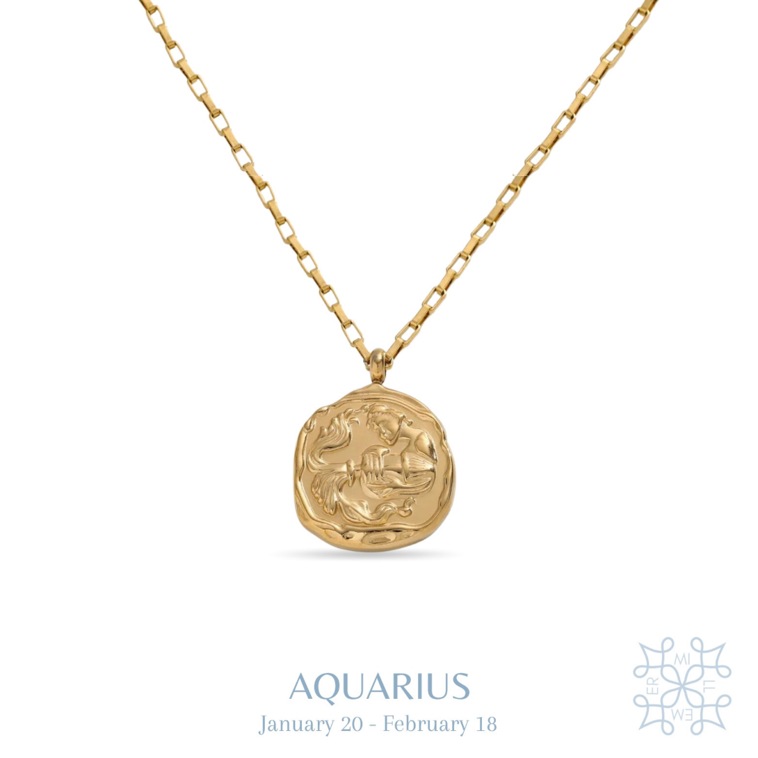 AQUARIUS Zodiac Medallion Gold Necklace. Irregular round medallion with an aquarius symbol in the middle. A vase throwing water in the middle of the medallion. The gold medallion is droped in a chain necklace.
