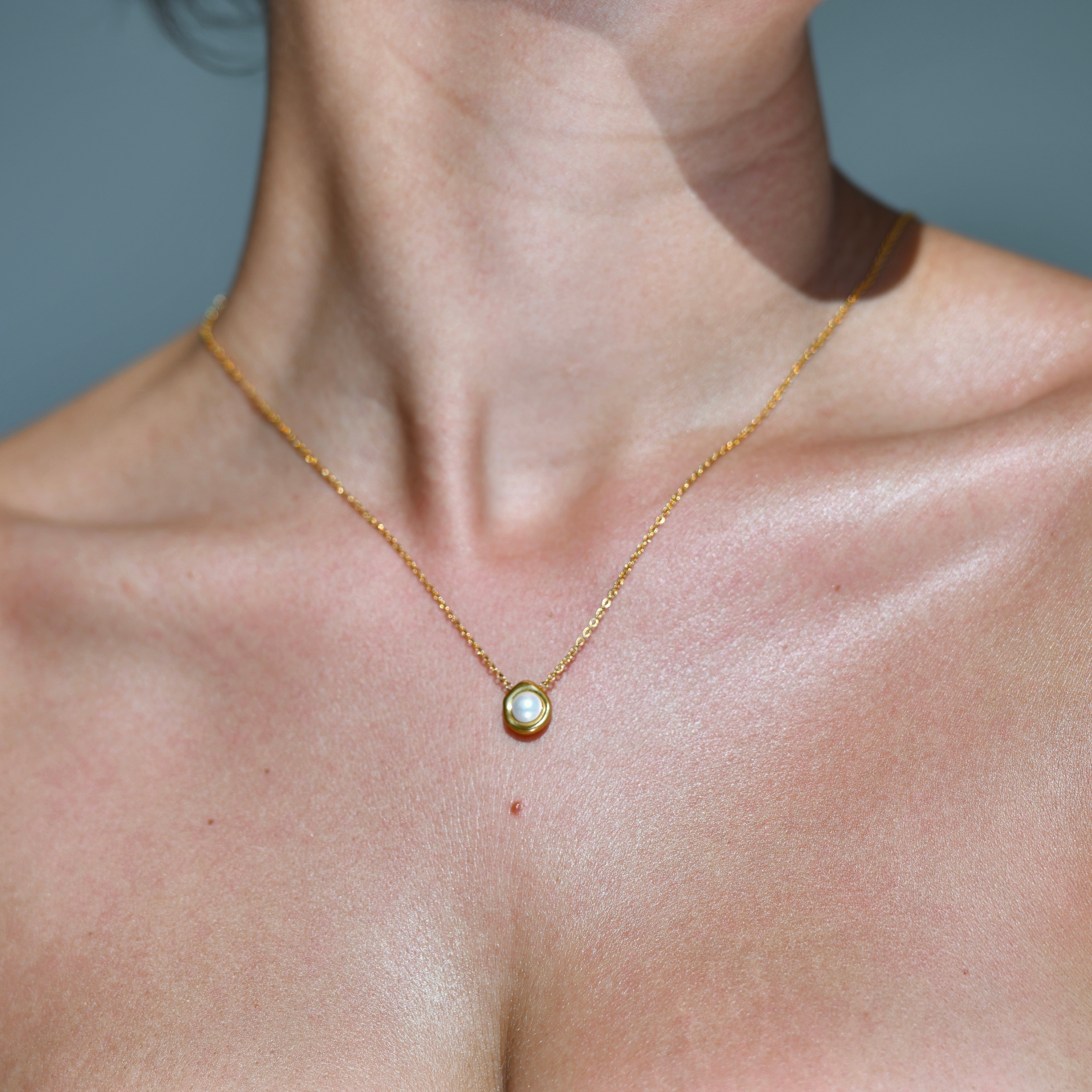CLAM Pearl Gold Necklace - GOLD plated chain with a small pendant. Gold oval irregular shape with a white pearl in the middle.