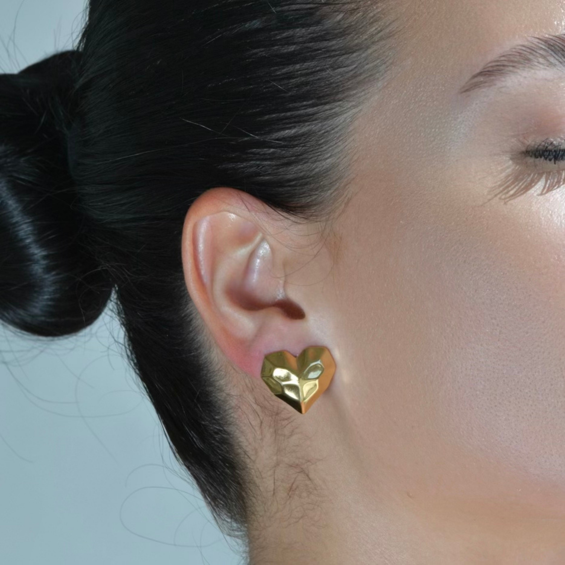 Heart shapped gold earrings. Hammered surface of the stud earrings. waterproof earrings