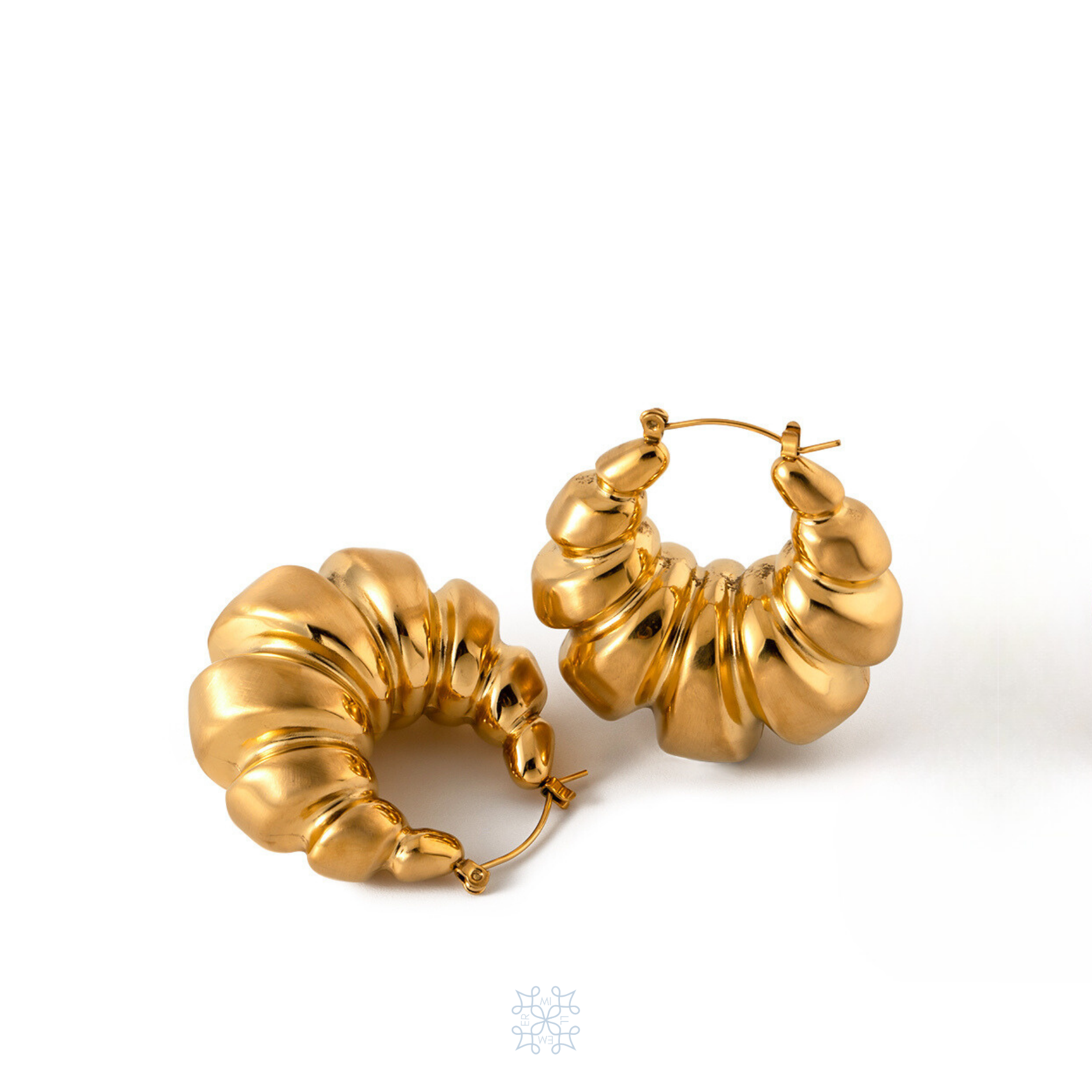 Croissant shaped chunky gold hoop earrings.