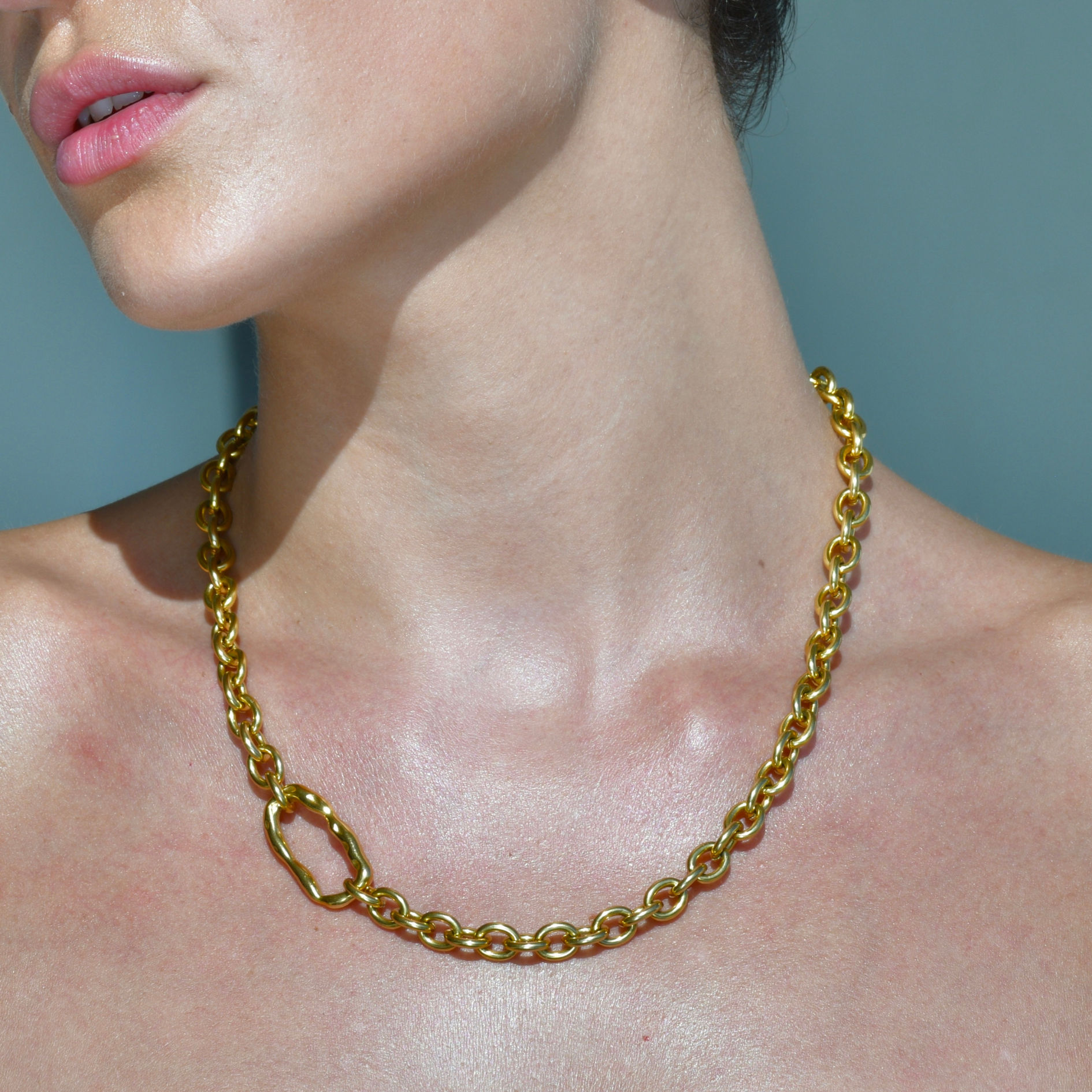 Bold Gold Chain with an irregular horizontal oval charm in the side of the chain. DUNE Gold Chain Necklace