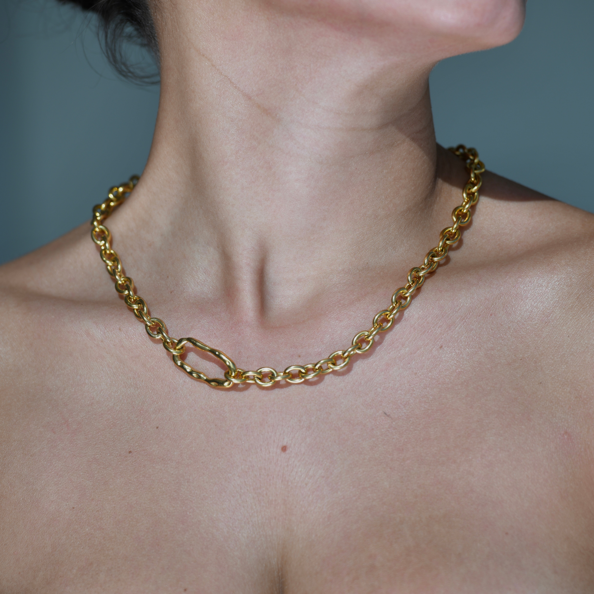  Bold Gold Chain with an irregular horizontal oval charm in the side of the chain. DUNE Gold Chain Necklace