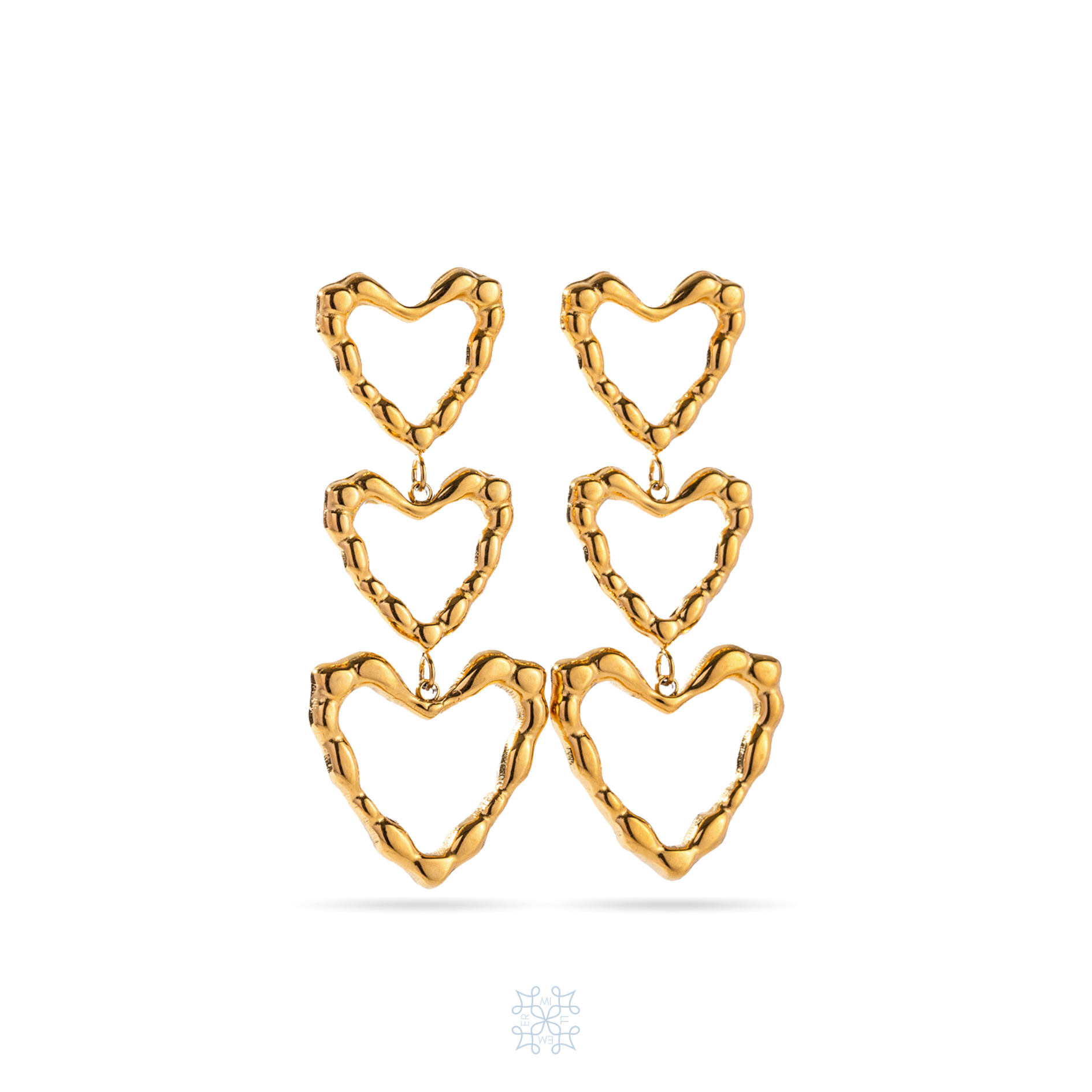 Gold Drop Earrings. Three Hearts attached one to another to form a drop earring. The hearts are empty in the inside surface forming onlu heart frames. The biggest heart drop at the bottom. The surface is irregular.