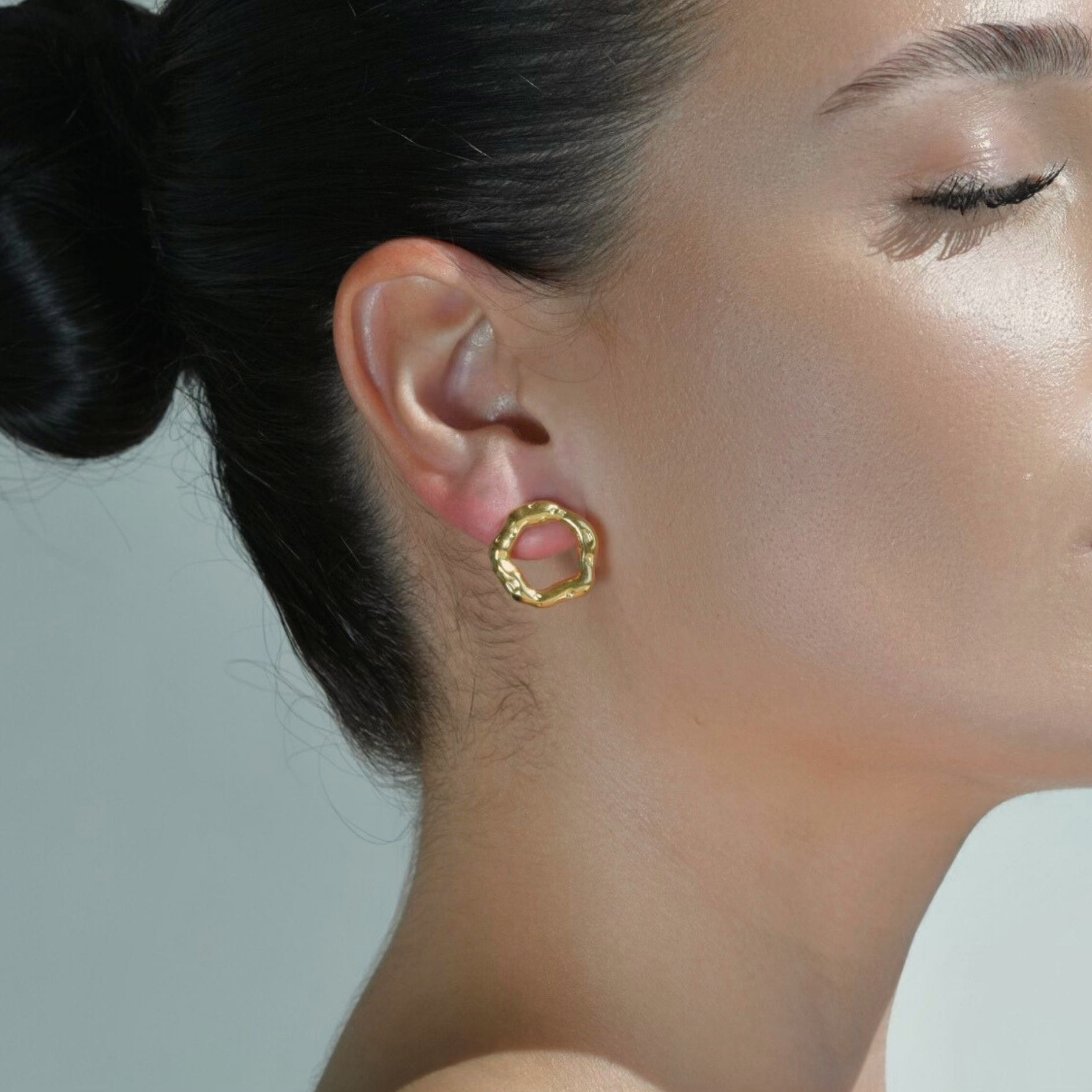 Circle Earrings with irregular shape. Gold plated with texture that imitates movement.
