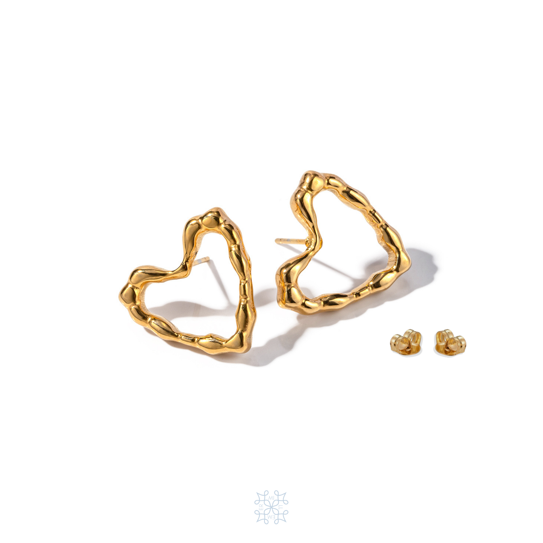 Heart shape gold stud earrings. Irregular surface on the border of the heart shape.