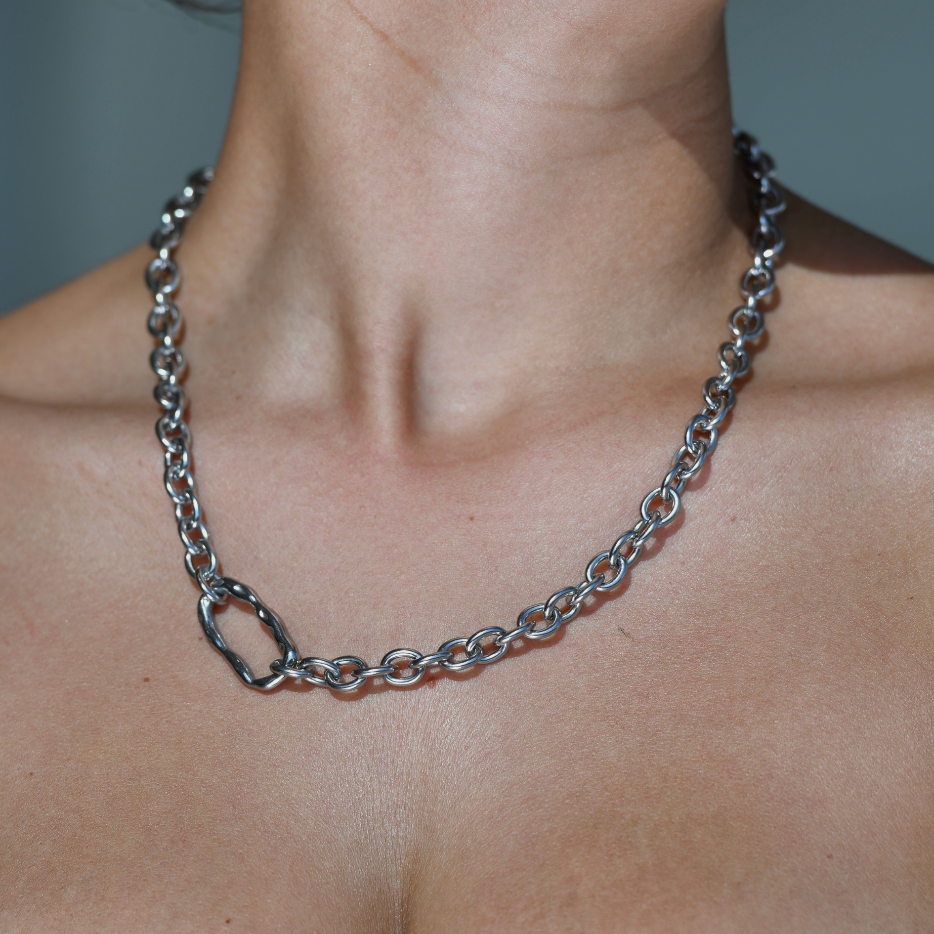 Bold Silver Chain with an irregular horizontal oval charm in the side of the chain. DUNE Silver Chain Necklace