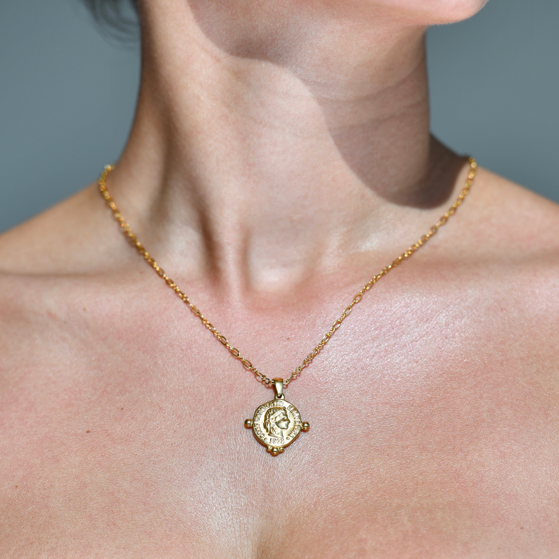 Gold chain necklace in the shape of baroque gold coin with a royal head in his surface. Irregular shape. Dynasty Coin Gol Pendant Necklace.