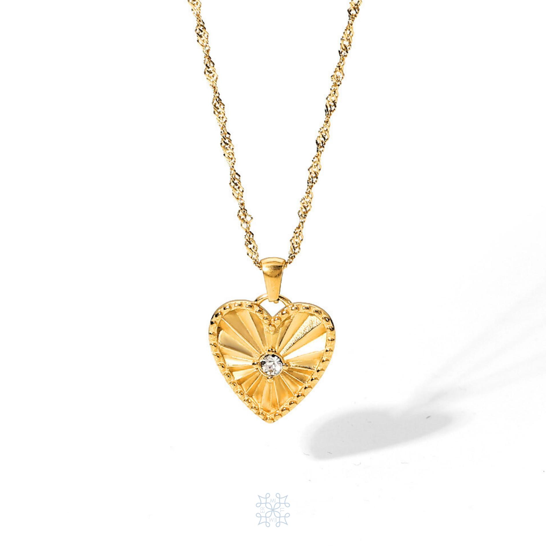 Gold plated waterproof chain necklace with a heart pendant droping on the chain. A zircon stone in the middle of the heart. The heart has engraved rays pattern starting from the middle opening the borders of the gold heart. Heart Pendant gold necklace.