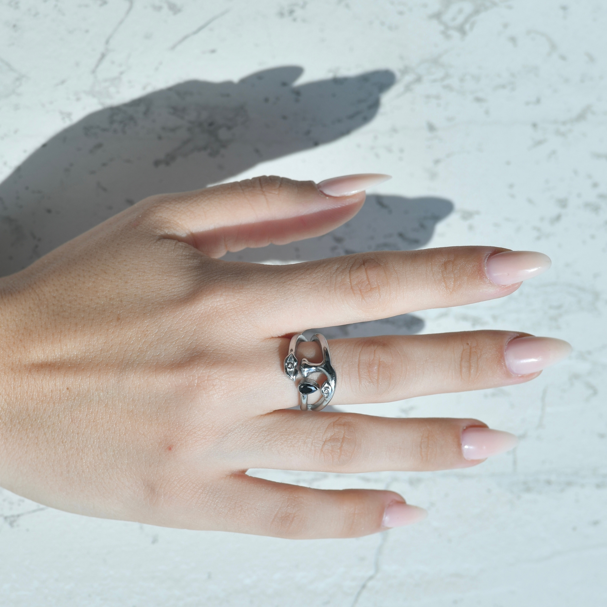Her face silver zircon ring. Surreal silver ring with the shape of a face , eyes, noes, lips and a teardrop with a black zircon attached on the drop. In the lip and eye it has a small white zircon