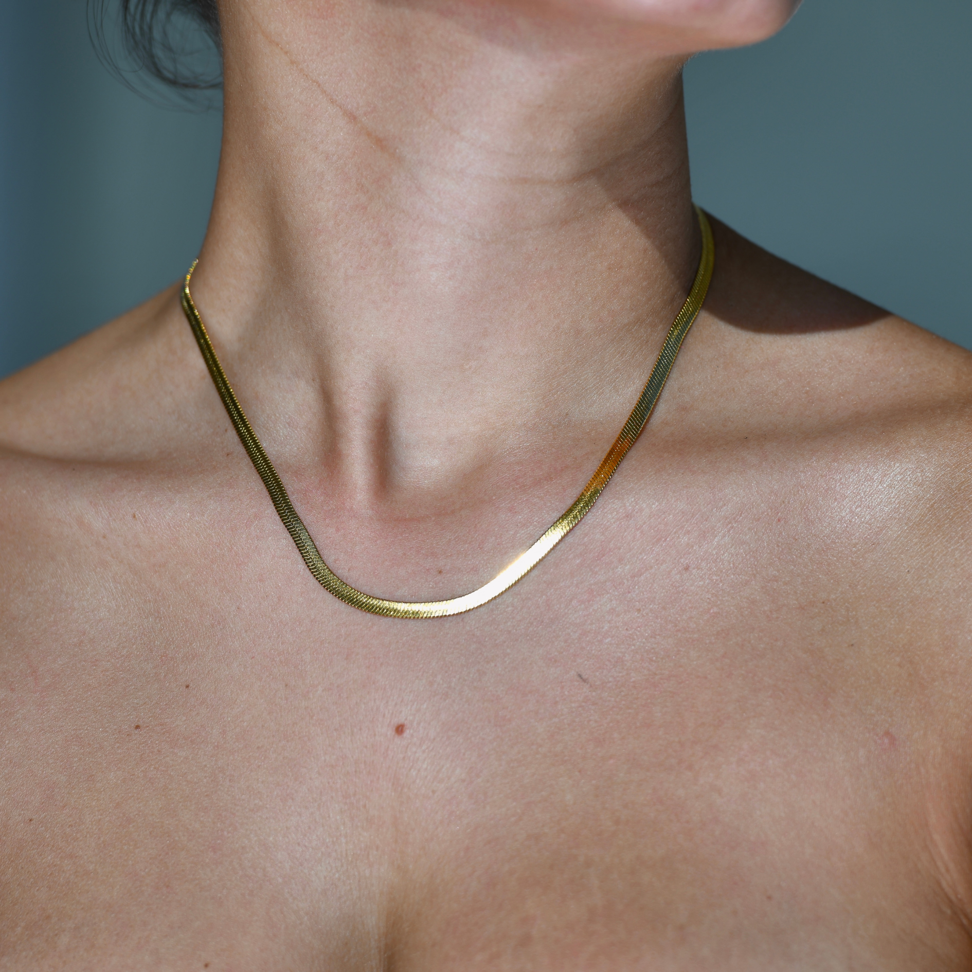 HERRINGBONE M GOLD CHAIN NECKLACE -Gold plated four mm width herringbone patern chain necklace.