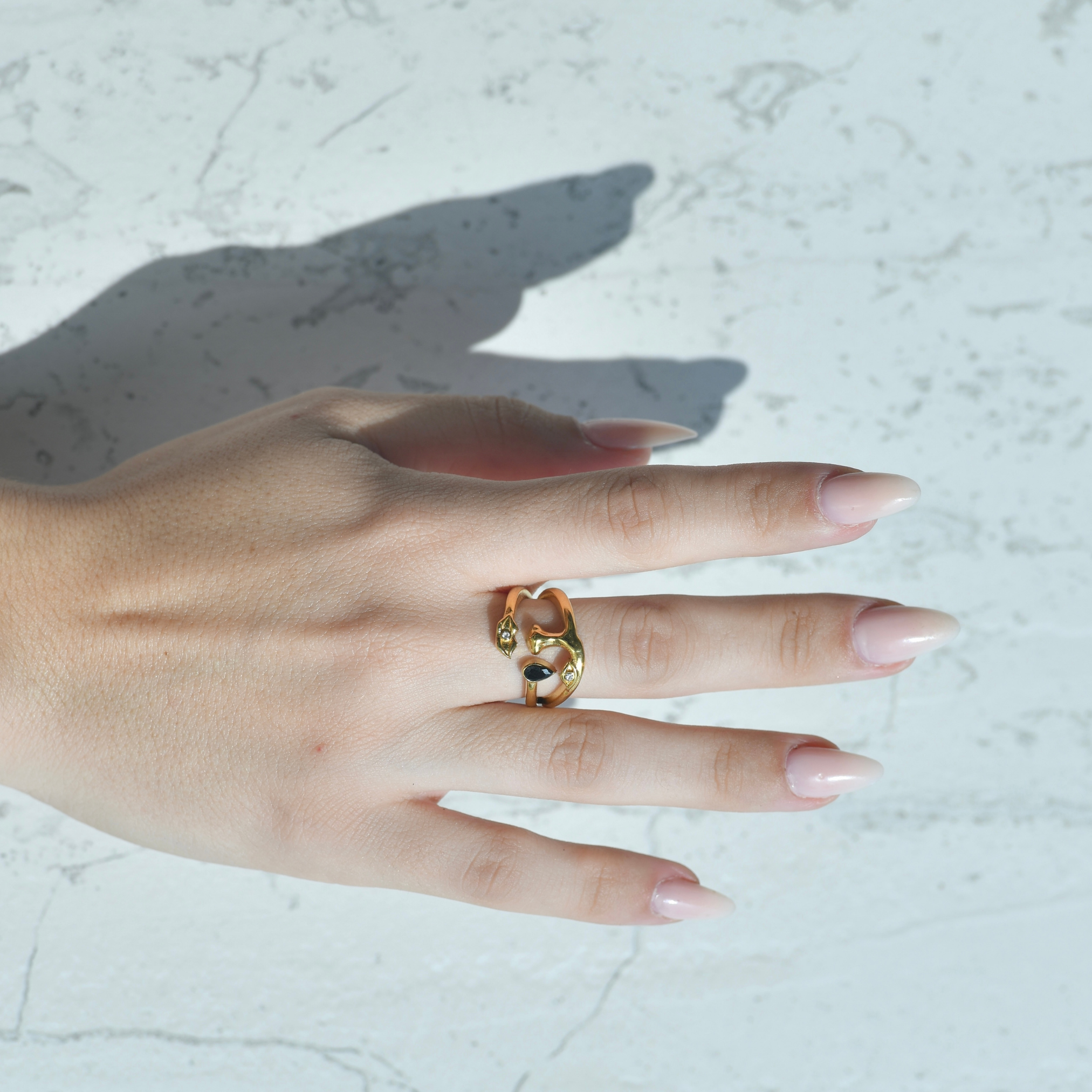 Her face gold zircon ring. Surreal gold ring with the shape of a face , eyes, noes, lips and a teardrop with a black zircon attached on the drop. In the lip and eye it has a small white zircon