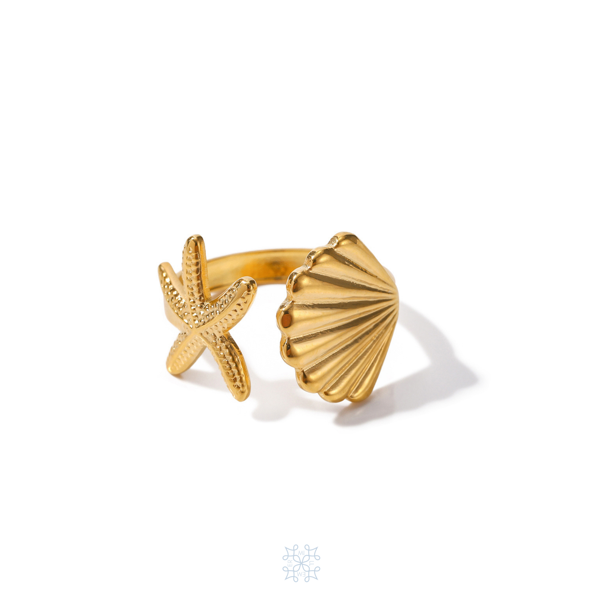 ISLE star and shell gold adjustable ring. A star fish on one side of the rinf and a shell on the other one. The front pf the ring is adjustable open space.