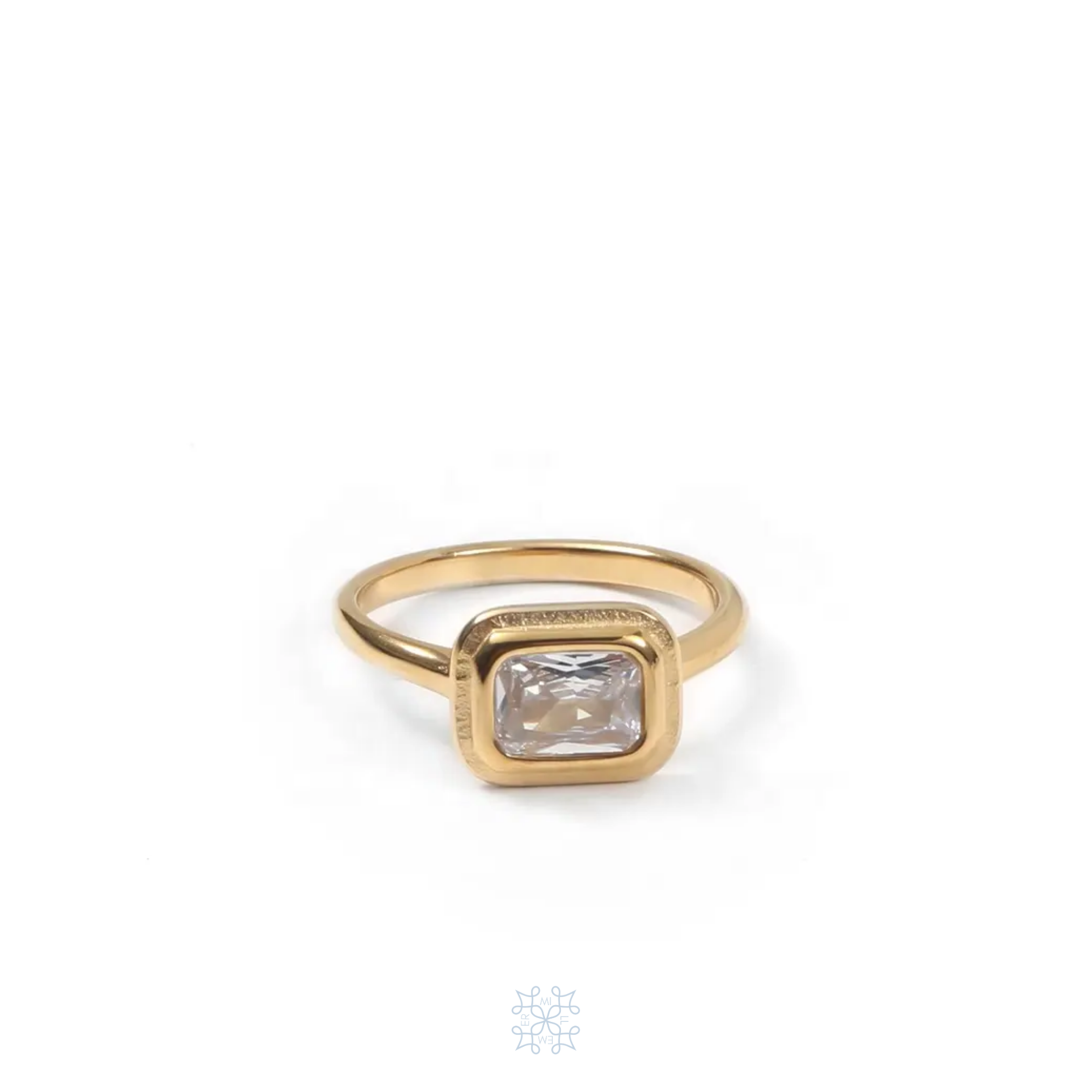 Gold halo ring with a rectangular zircon on the top of the ring. 