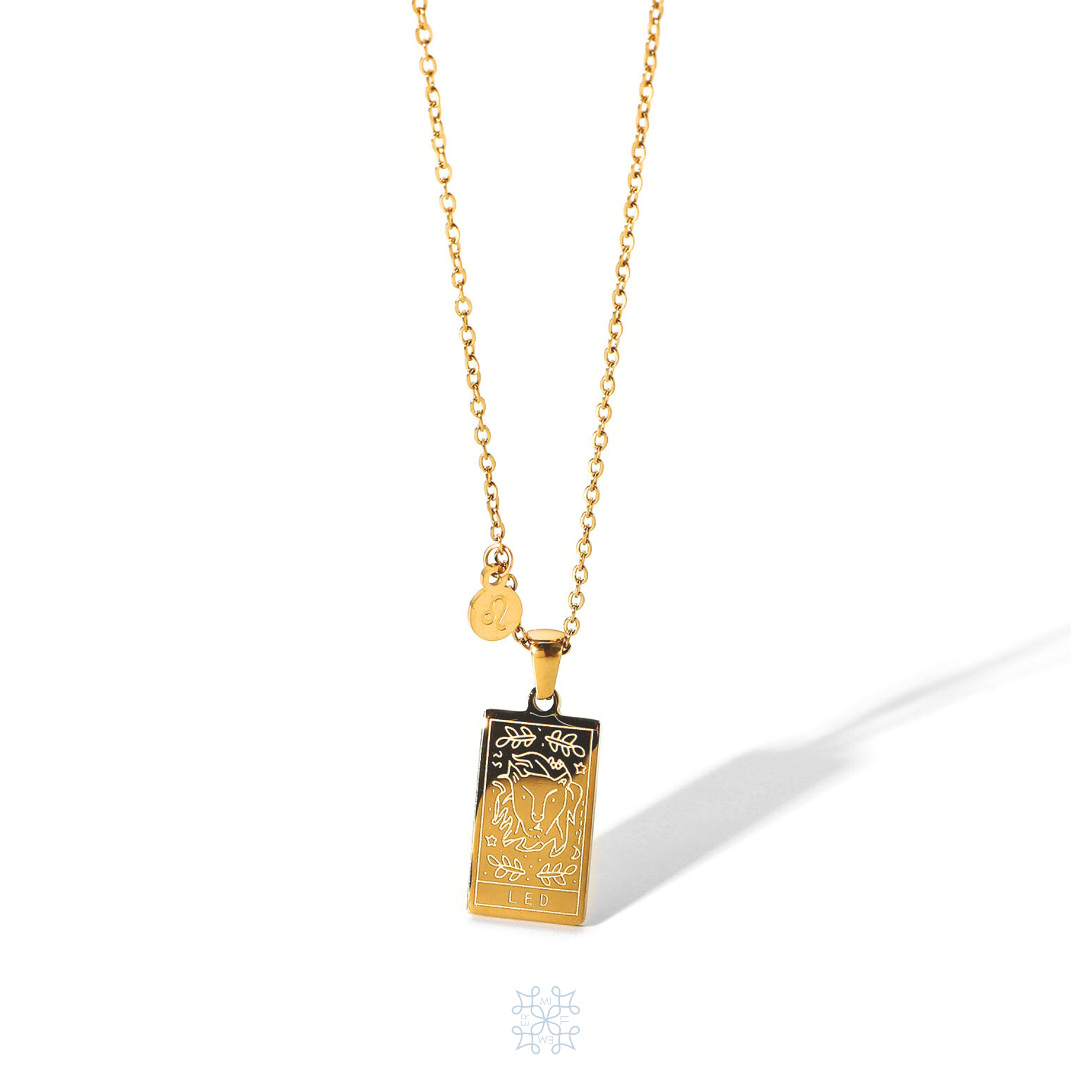 Rectangular gold pendant with Leo engraved and the word Leo in the bottom. Gold pendant with a chain necklace. In the side of the gold pendant is a circle small medallion with the symbol of Leo engraved on it. Leo zodiac pendant gold necklace.