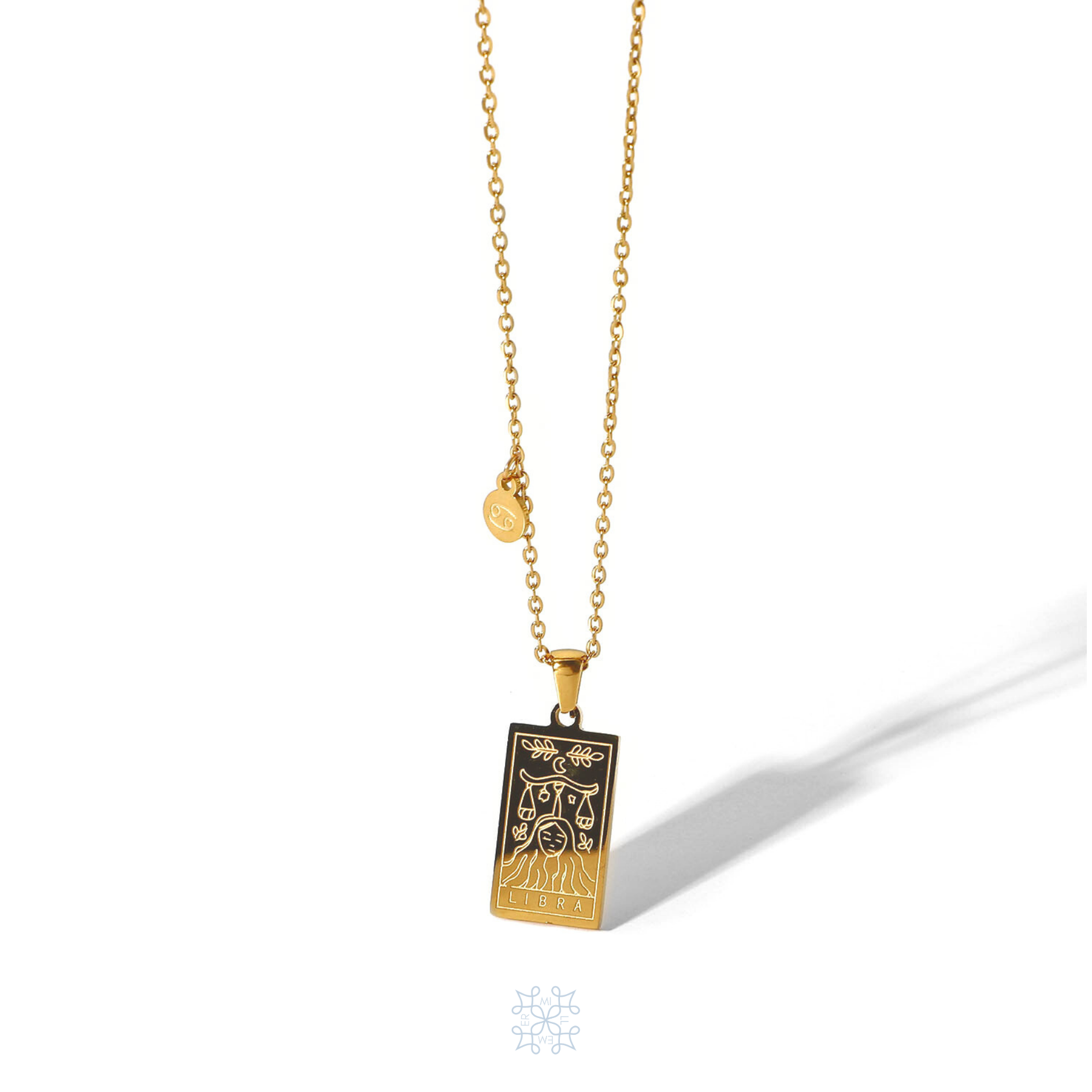 Rectangular gold pendant with Libra engraved and the word Libra in the bottom. Gold pendant with a chain necklace. In the side of the gold pendant is a circle small medalion with the symbol of Libra engraved on it. Libra zodiac pendant gold necklace.