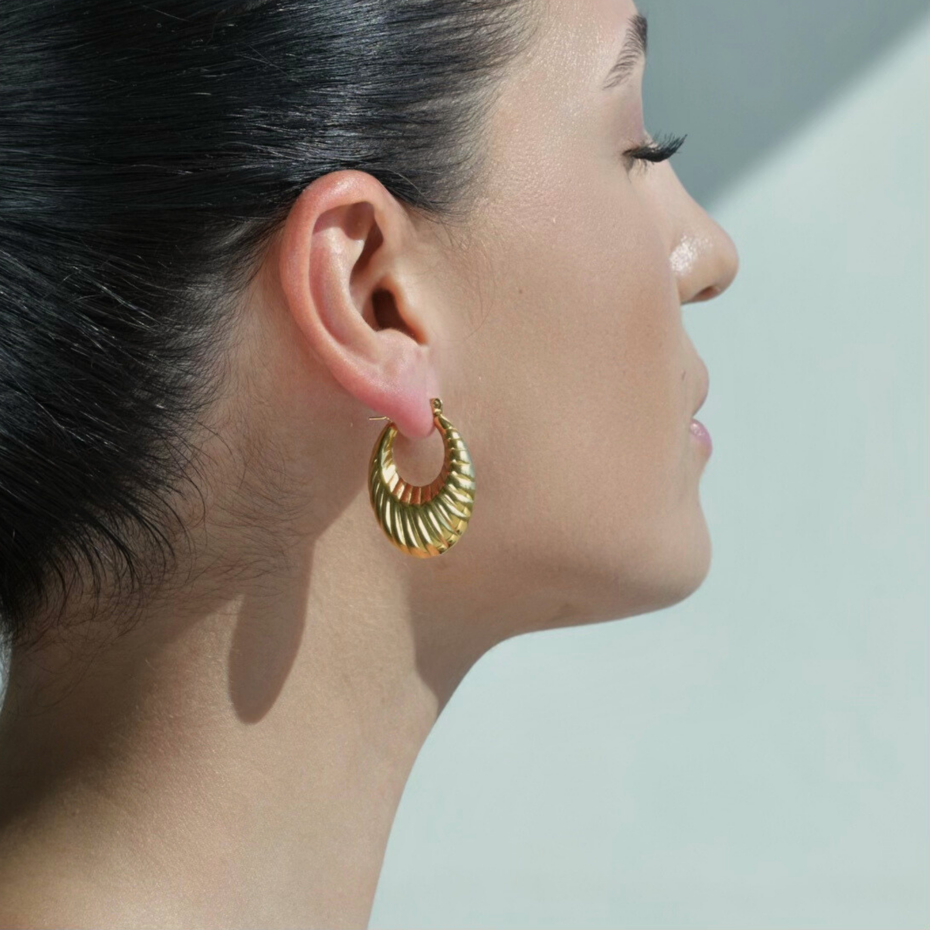  Oval shaped gold hoop earrings. Chunky look in the bottom part of the oval.