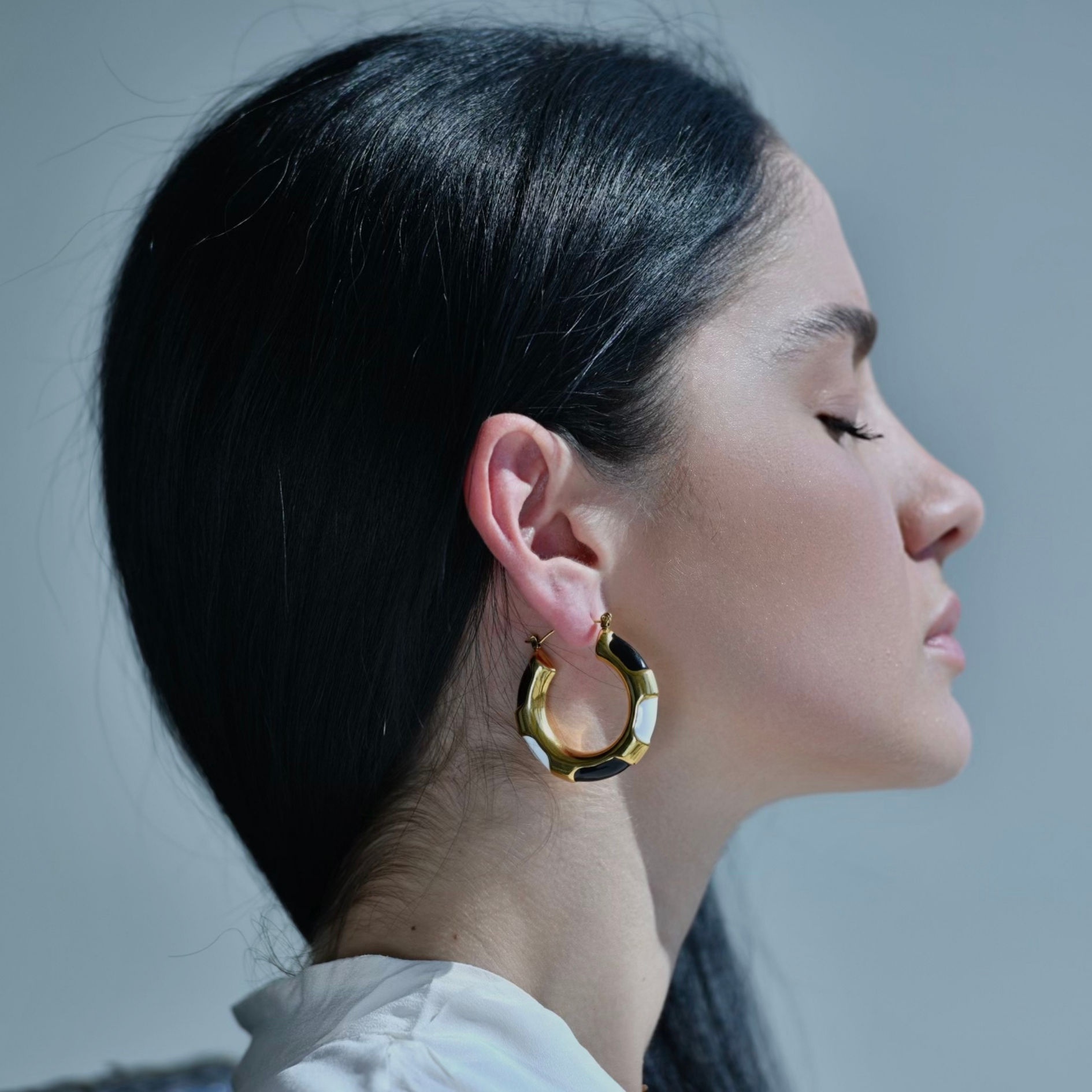 MONOCHROME - Gold Hoops Painted in white enamel and black enamel. Model photo wearin the earrings.