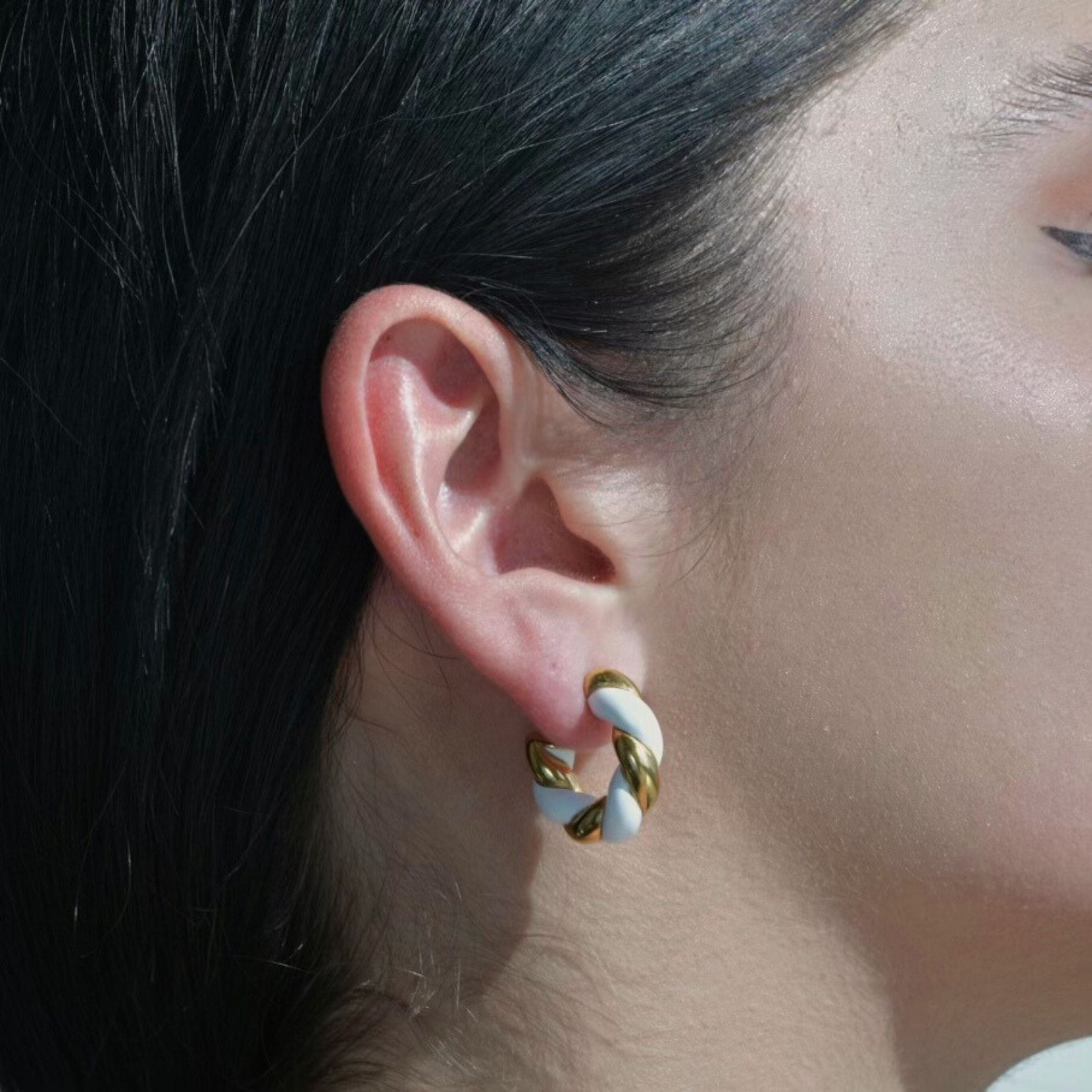 NORTH Gold Earrings Hoops White Enamel Painted. the surface of the hoop is ltwisted in 2 colours gold plated part and white enamel