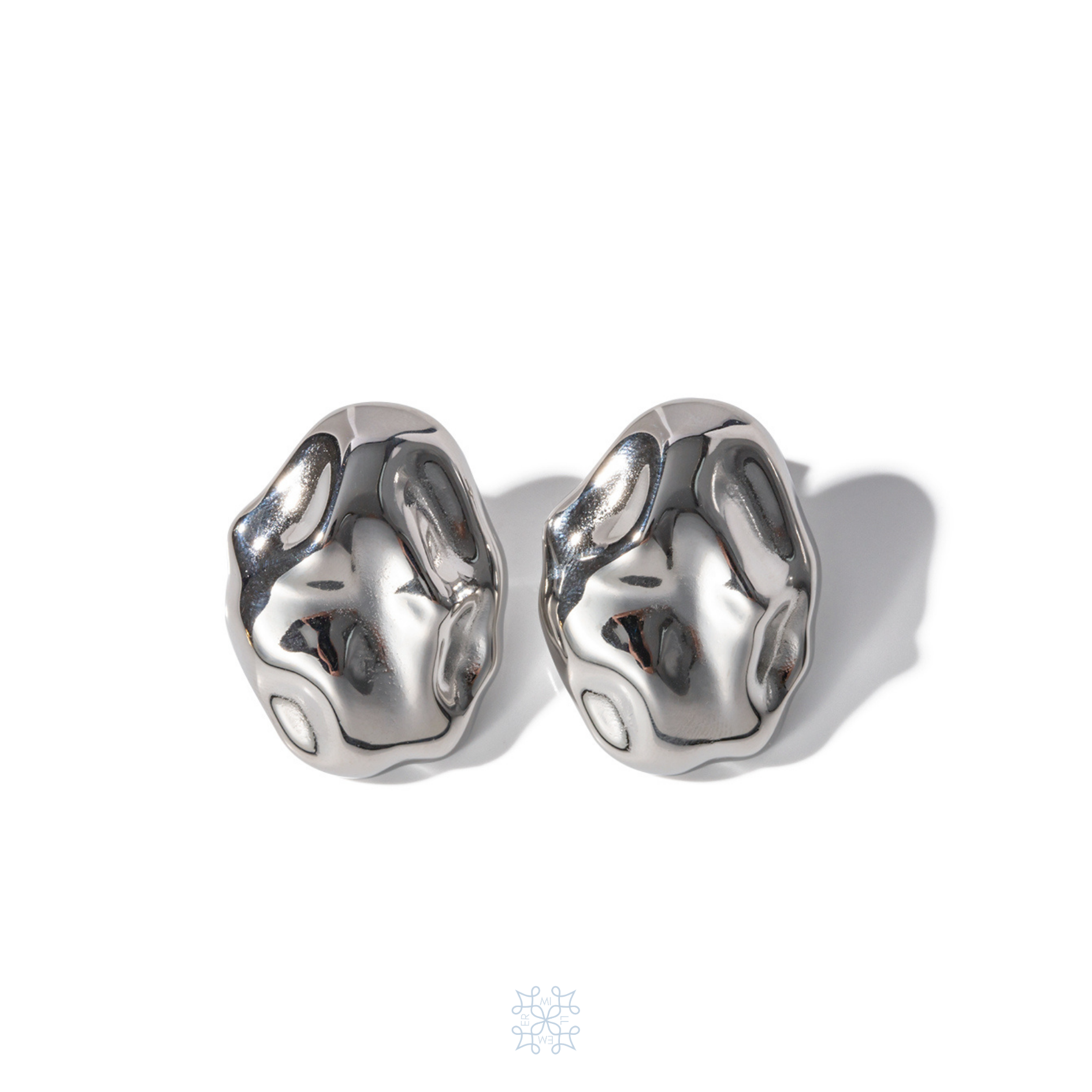 Silver Oval Earring with an irregualr surface resembling an hammered metal with the shape of an oval rock. Silver Plated. Pebble Silver Earrings