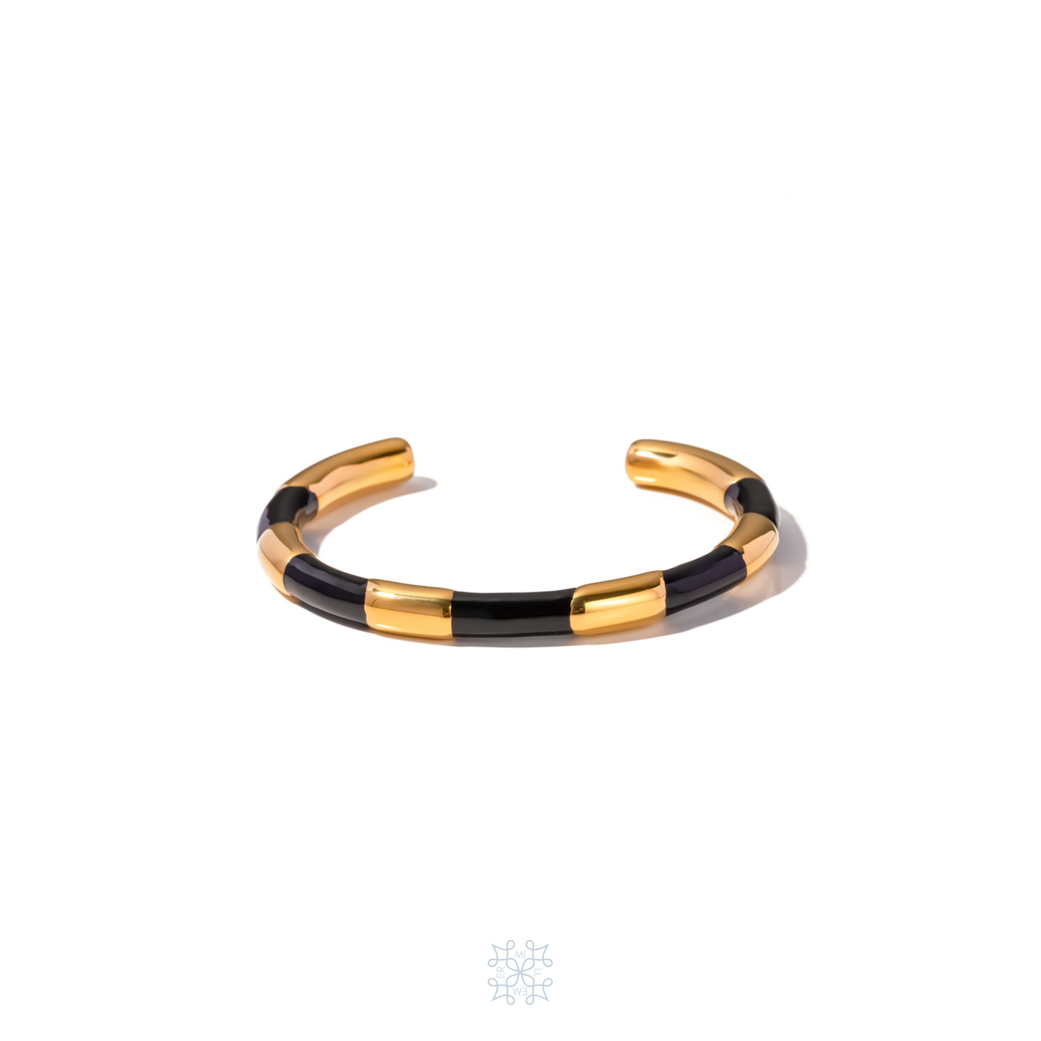 Gold Cuff bracelet. Black enamel painted creating the idea of a black ribbon around the gold cuff.