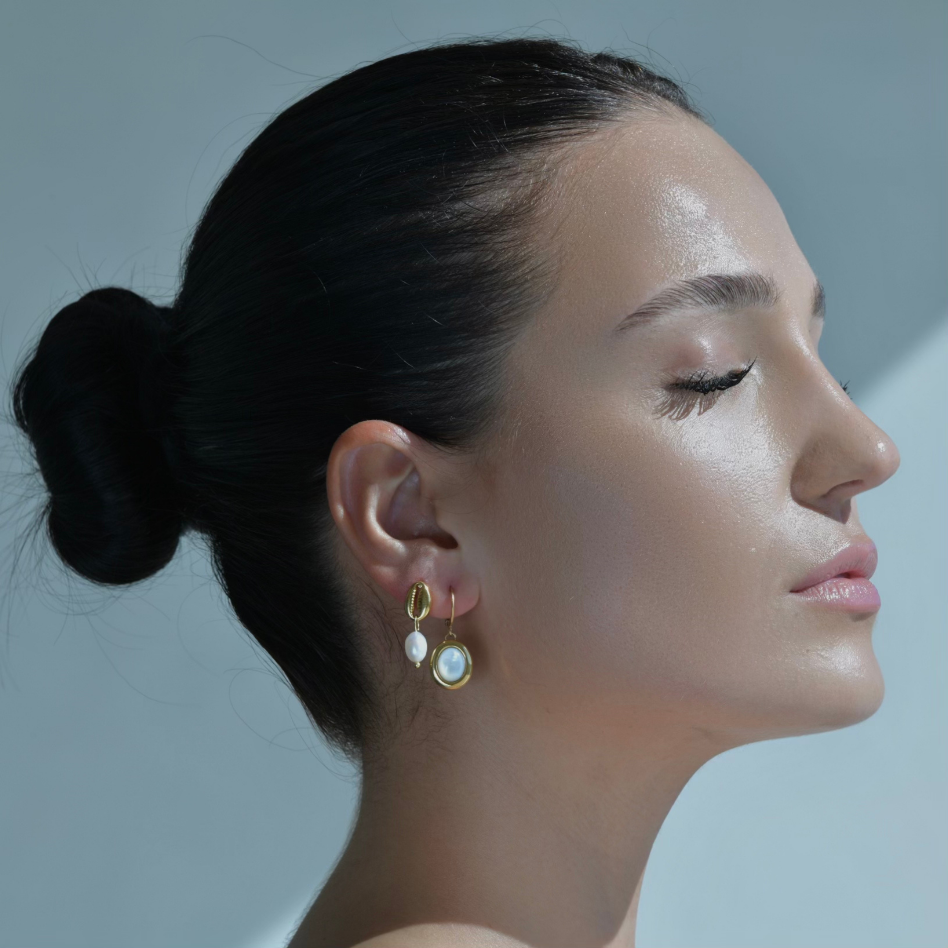 Gold hoop earrings with oval mother pearl drop. 