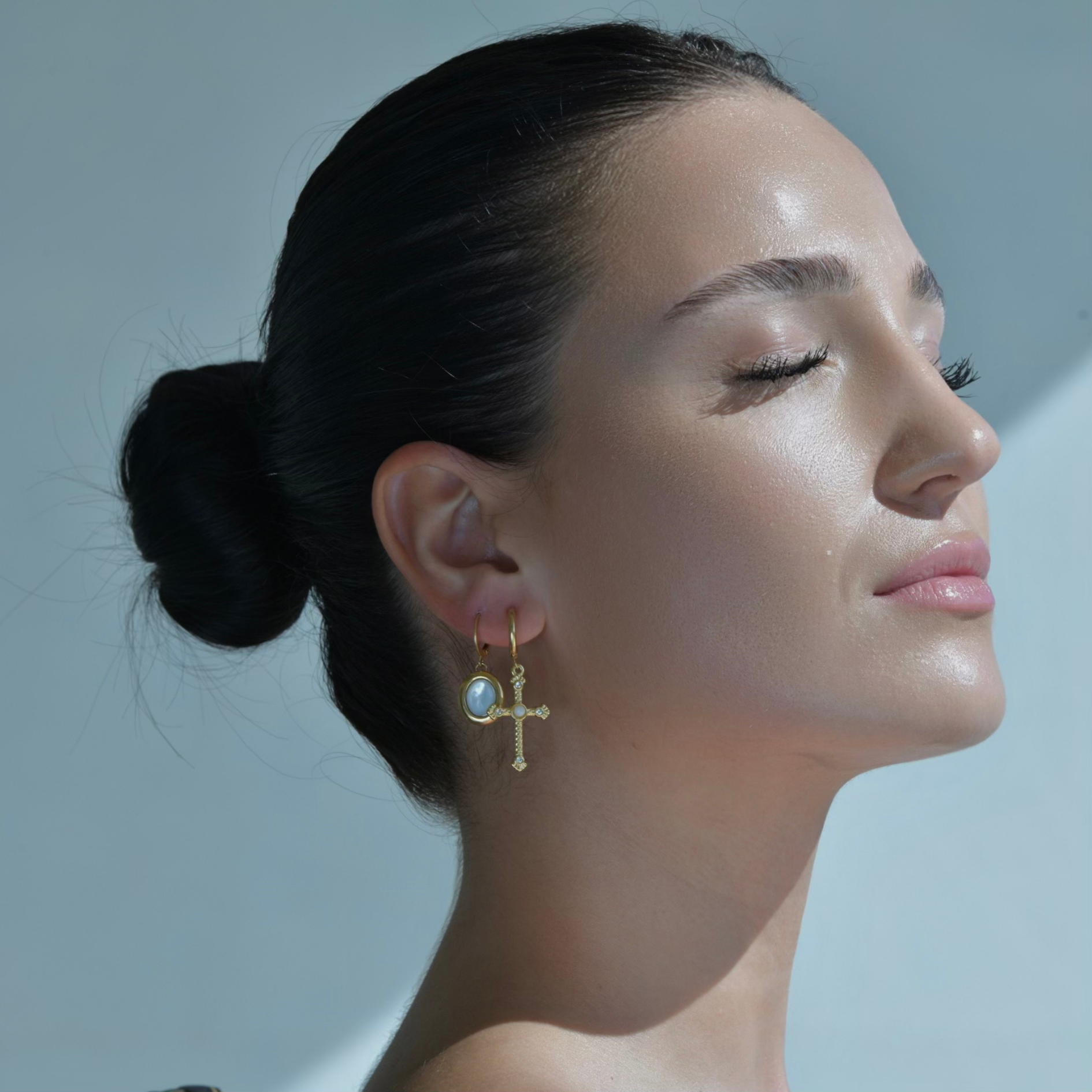 Gold hoop earrings with oval mother pearl drop. The Capri Cross Zircon Earring coupled with Seine Earrings