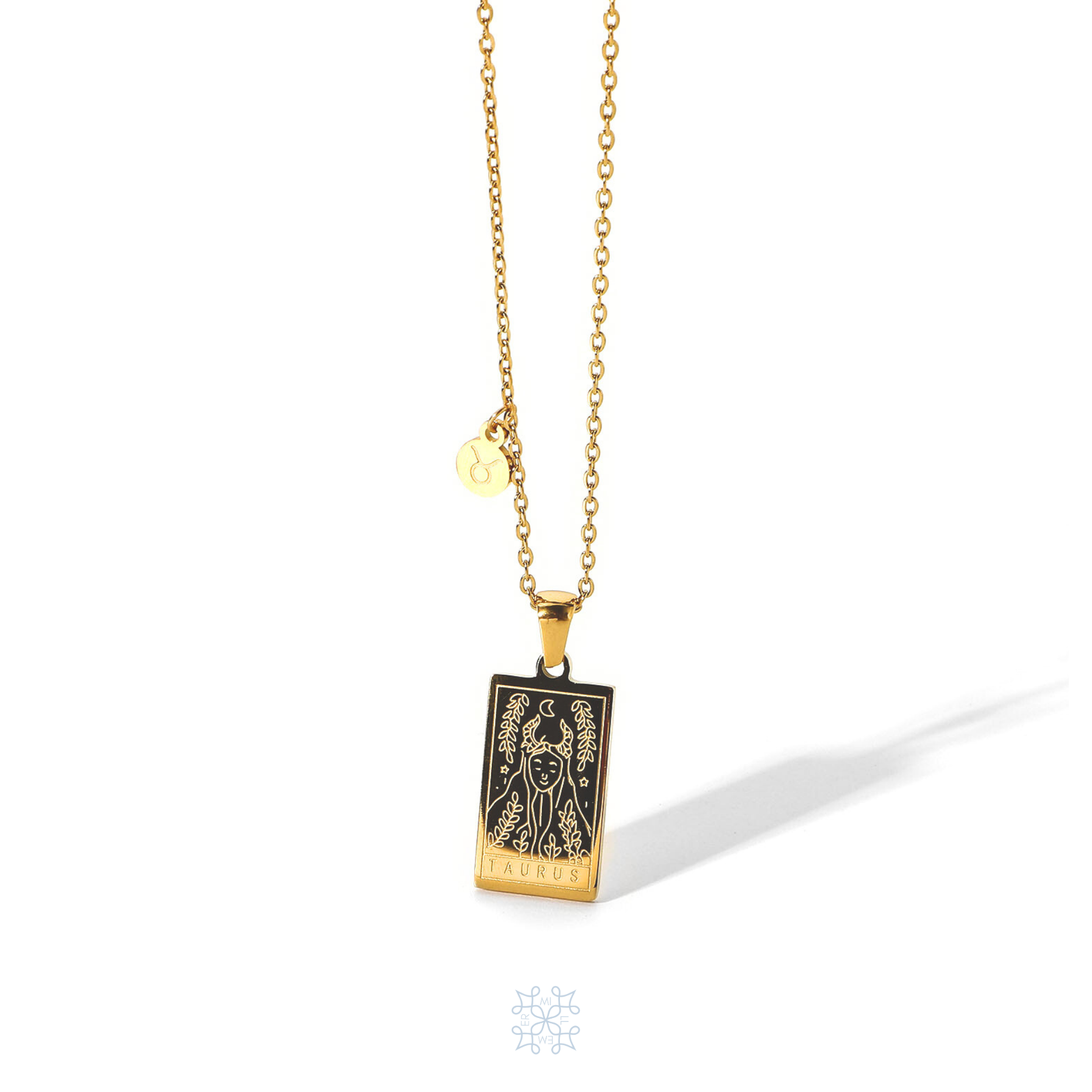 Rectangular gold pendant with Taurus engraved and the word Taurus in the bottom. Gold pendant with a chain necklace. In the side of the gold pendant is a circle small medallion with the symbol of Taurus engraved on it. Taurus zodiac pendant gold necklace.