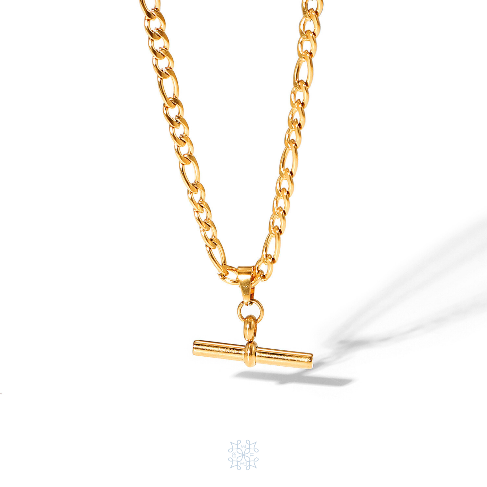 Figaro chain gold necklace with a T shape pendant hanging at the middle of the necklace.