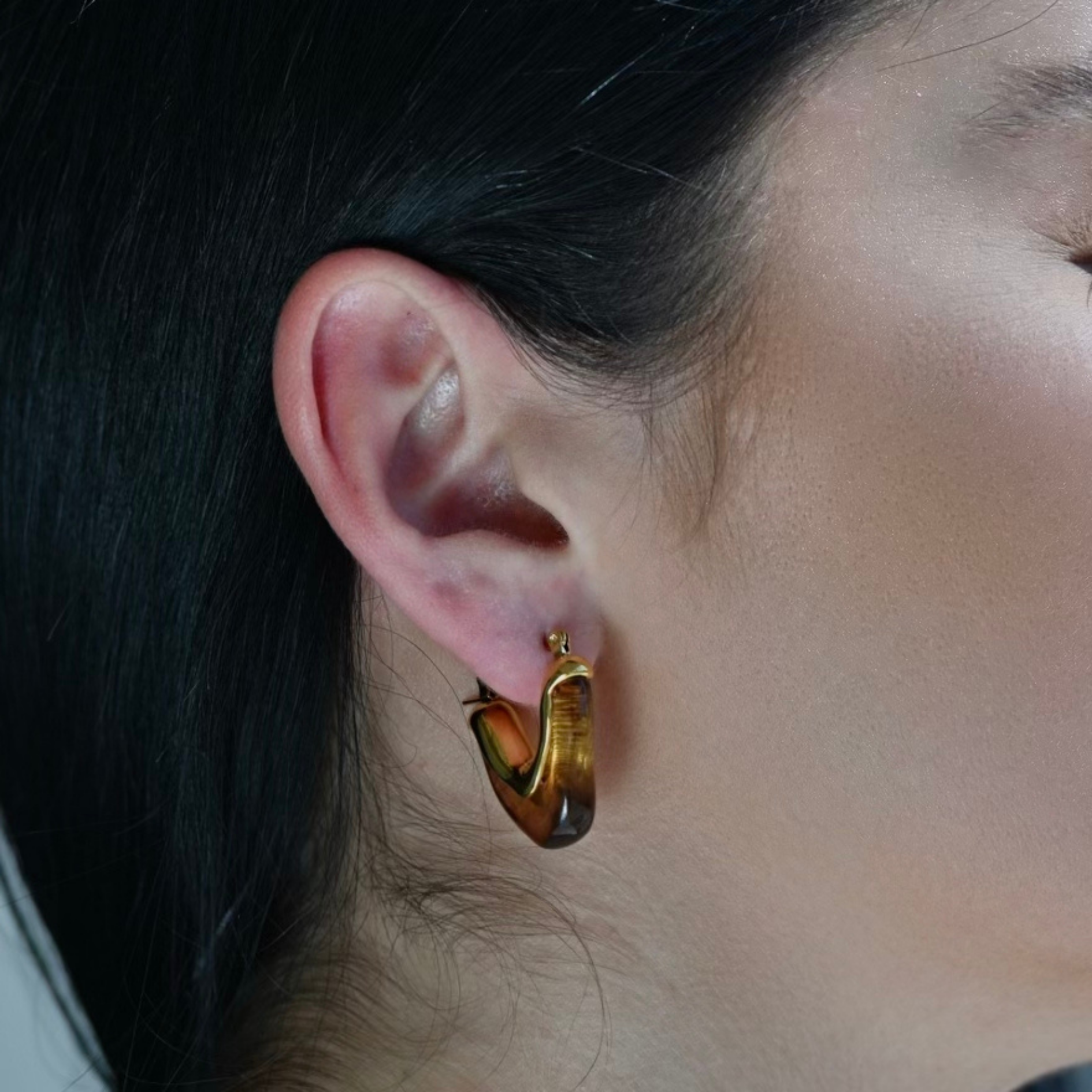 Model wearing a V shape Gold Plated  Hoop Earrings made with Brown Acrylic. Waterproof Earrings.