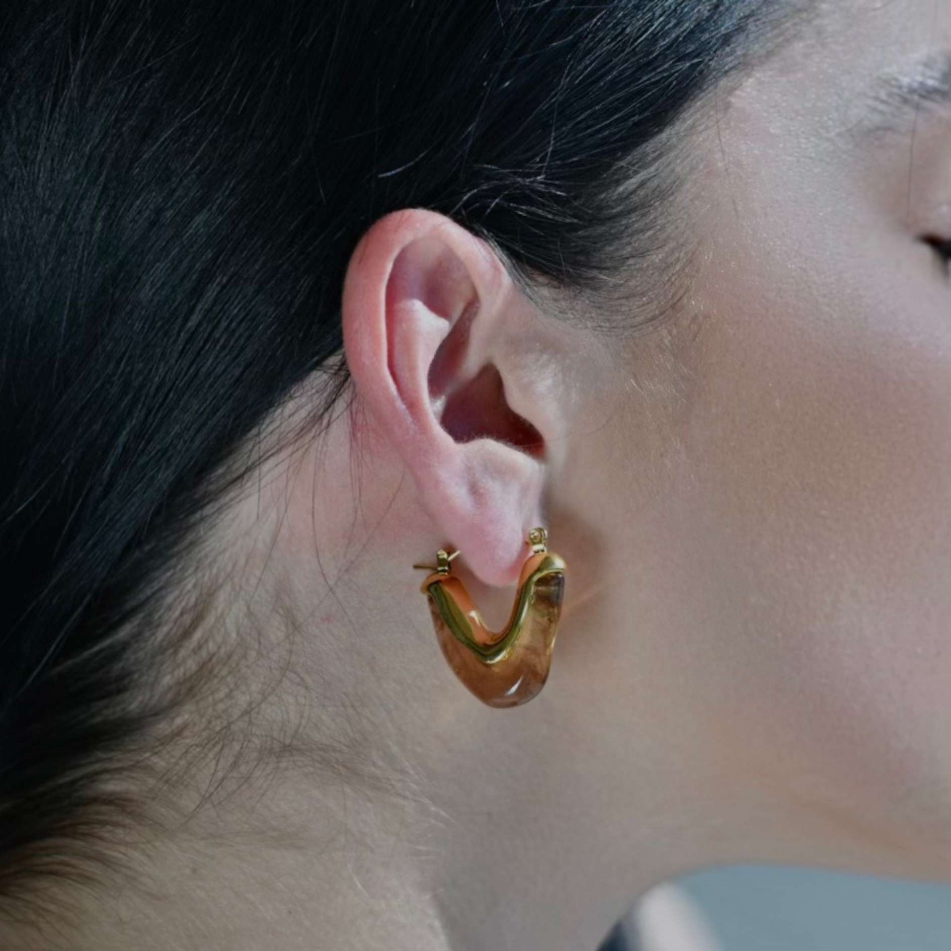 Model wearing a V shape Gold Plated  Hoop Earrings made with Brown Acrylic. Waterproof Earrings.