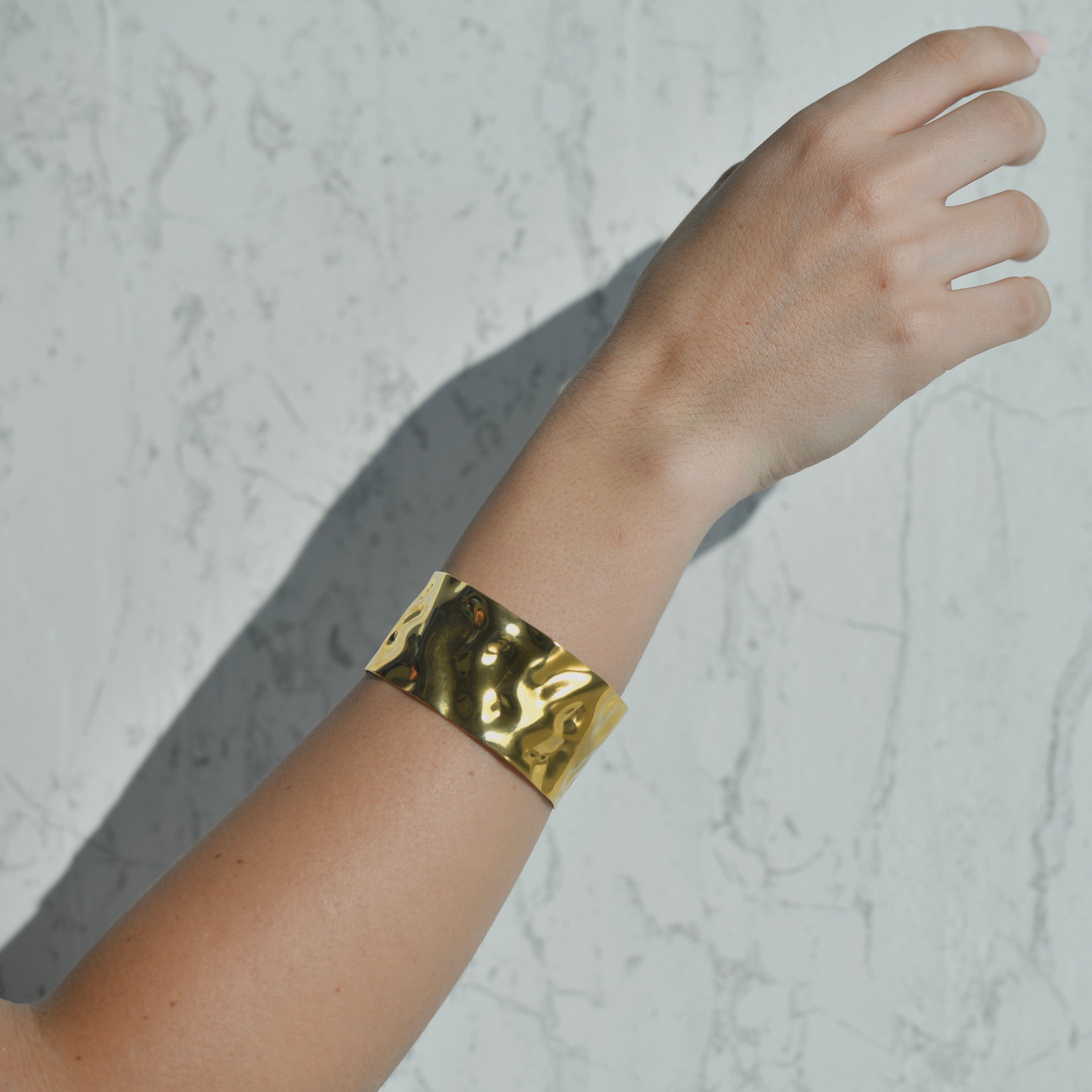Wave gold cuff bracelet. Gold hammered irregular shiny surface of the gold cuff bracelet. Adjustable opening.